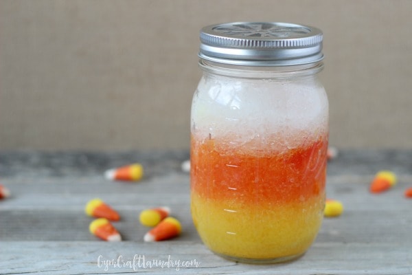 A jar of handmade candy corn scented air freshener by GymCraftLaundry.