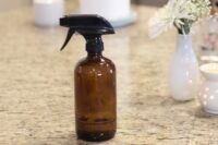 DIY Granite Cleaning and Sanitizing spray in a glass bottle